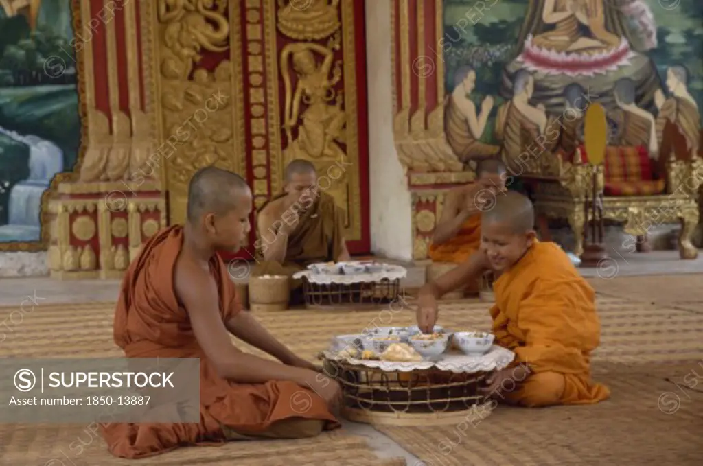 Laos, Vientiane, Buddhist Monks Eating Meal In Wat Chan.