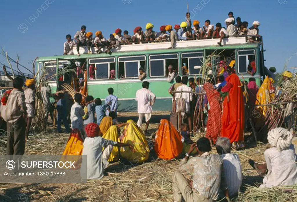 India, Rajasthan, Pushkar, Over Crowded Bus With Passengers On The Roof