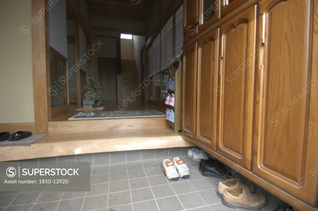 Japan, Housing, Entrance To Modern Family Home With Removed Shoes Left By Step.