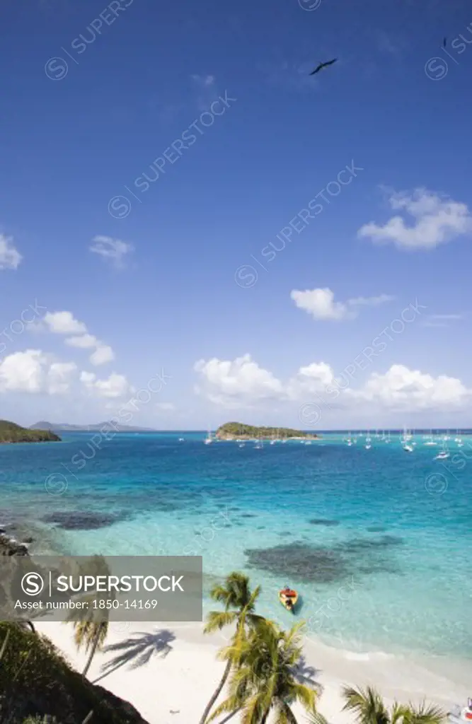 West Indies, St Vincent & The Grenadines, Tobago Cays, View Across The Beach At Jamesby Island And Moored Yachts Towards Canouan On The Horizon