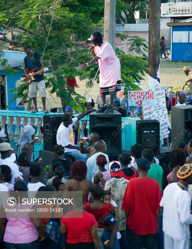 West Indies, St Vincent & The Grenadines, Union Island, Singer And Guitarist With Sound System At Easterval Easter Carnival In Clifton