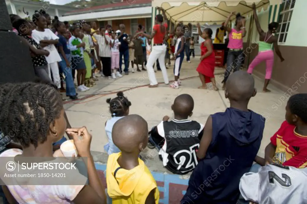 West Indies, St Vincent & The Grenadines, Union Island, Children Watching Other Children Dancing To A Sound System At The Easterval Easter Carnival In Clifton