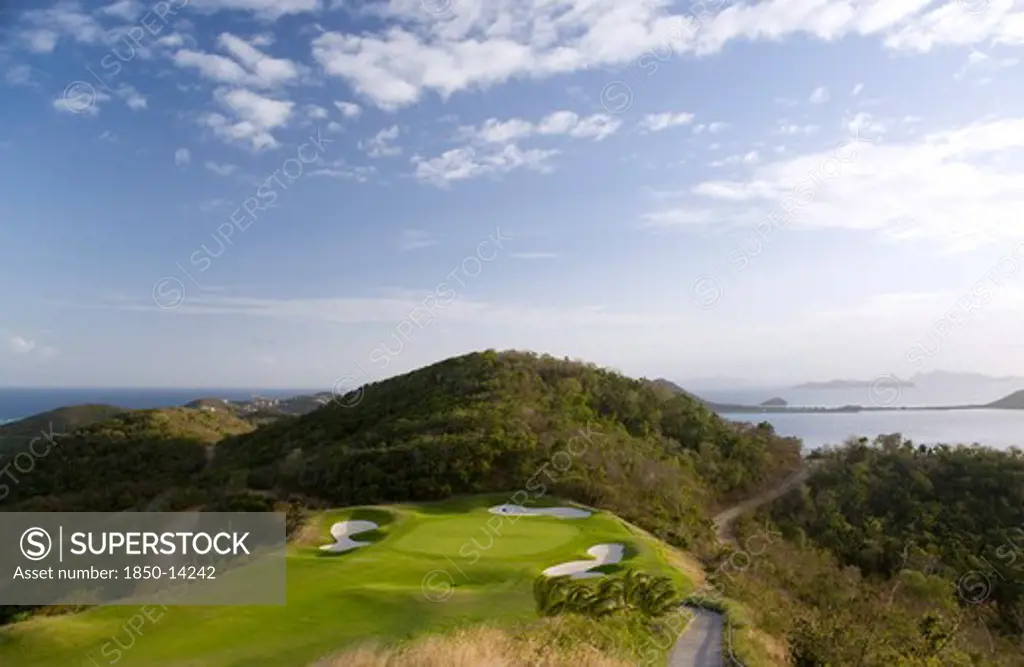 West Indies, St Vincent & The Grenadines, Canouan, Raffles Resort Showing The 12Th Green On The Trump International Golf Course With The Southern Grenadine Islands In The Distance