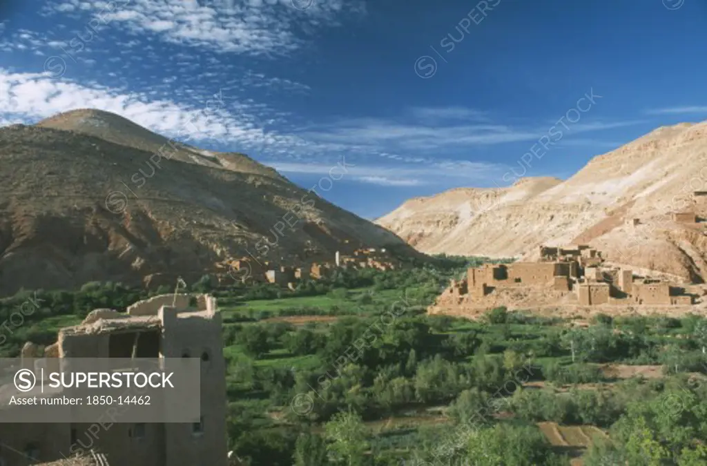 Morocco, High Atlas Mountains, Tioughassine, Kasbah And Village Overlooking Fertile Valley.