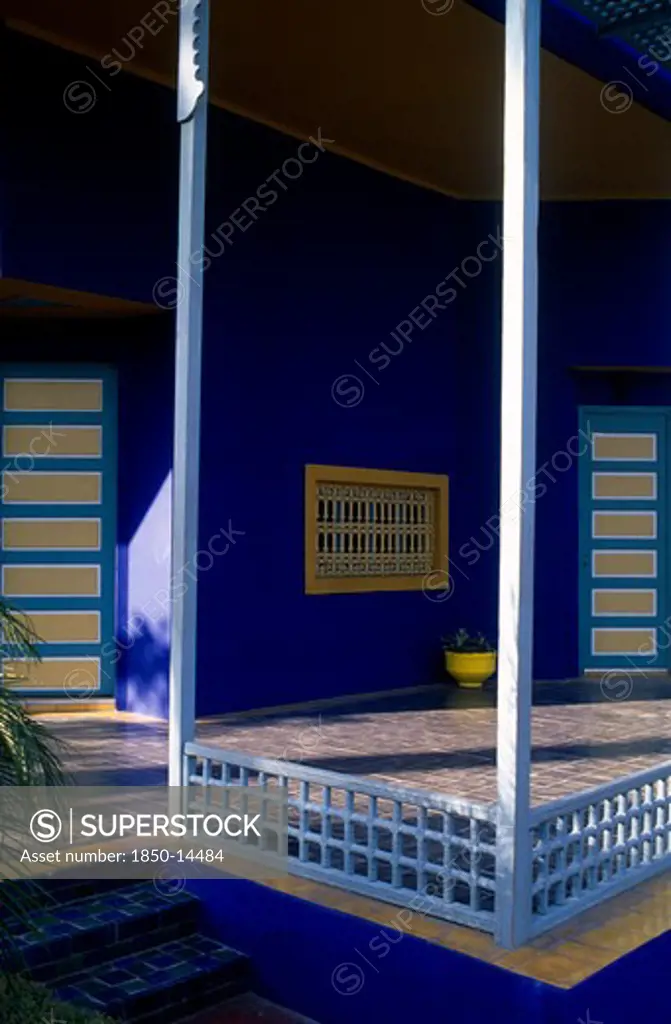 Morocco, Marrakesh, The Jardin Majorelle Owned By Yves St Laurent.  Corner Of Balcony With Walls Painted Vivid Blue.