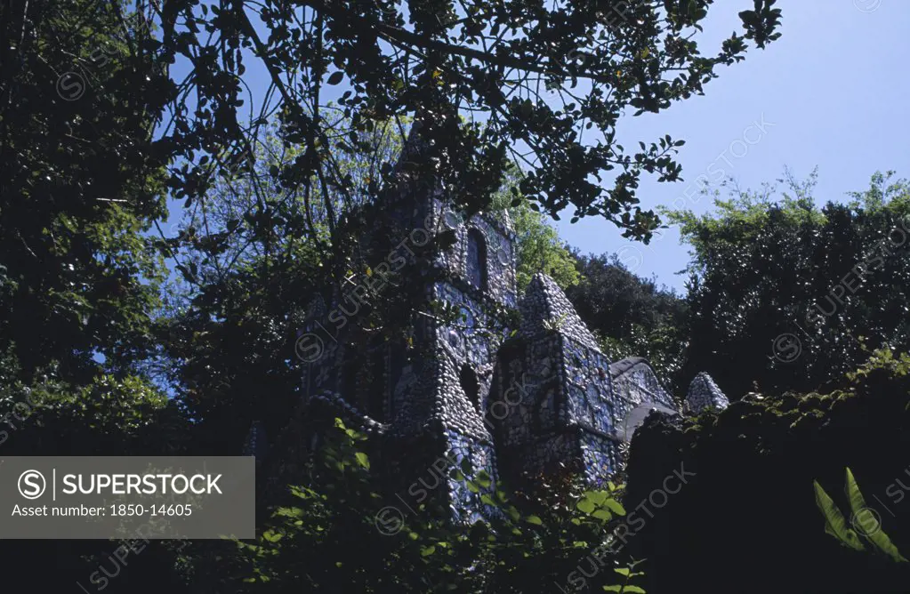 United Kingdom, Channel Islands, Guernsey, St Andrews. Les Vauxbelets.The Little Chapel Seen Through Tree Branches.