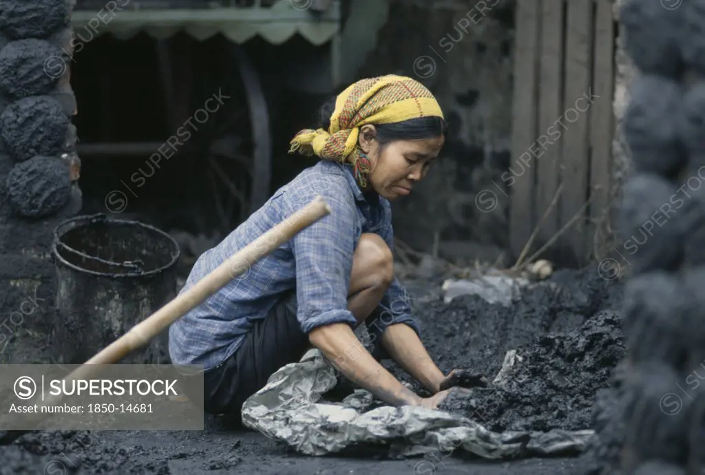 Vietnam, Work, Woman Making Cakes Of Coal Dust Used As To Fire Kilns.