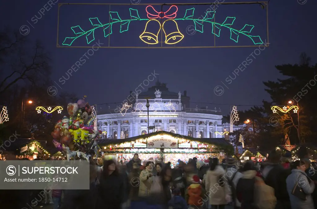 Austria, Lower Austria, Vienna, The Rathaus Christmas Market With The Burgtheater In The Background.