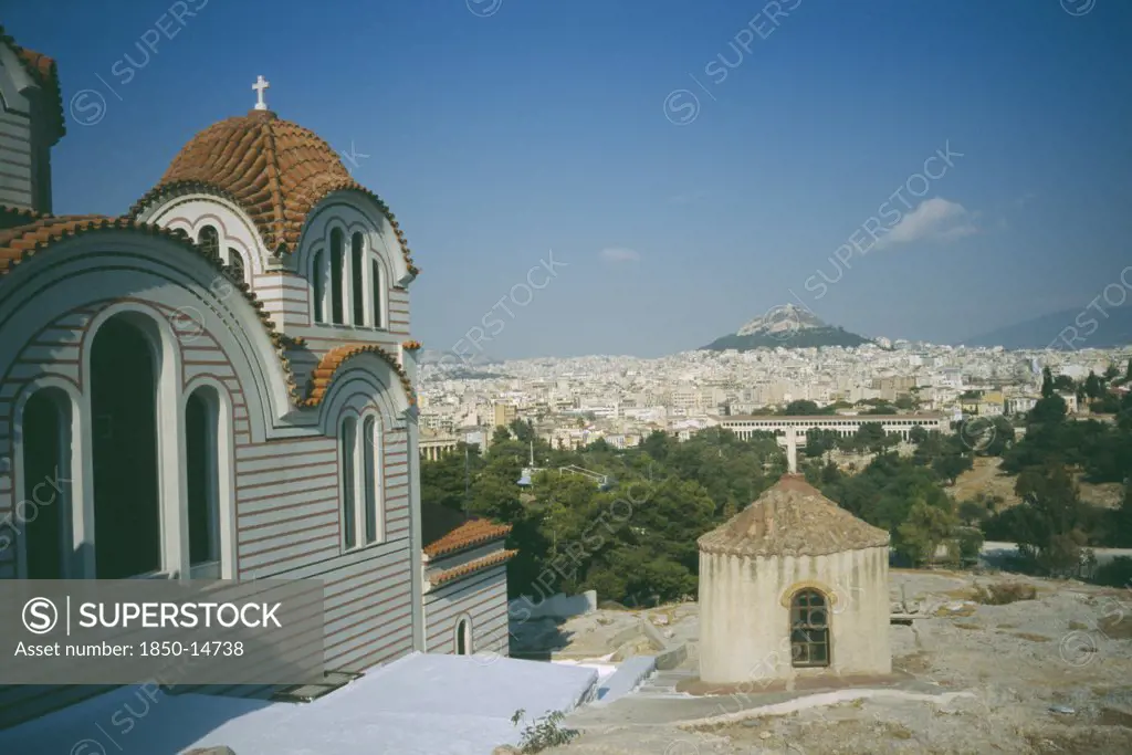 Greece, Central, Athens, View Of A Church In The Foreground And Acropolis And Lykavitos In The Distance.