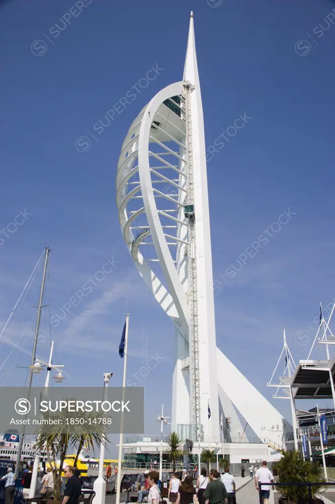 England, Hampshire, Portsmouth, The Spinnaker Tower The Tallest Public Viewing Platforn In The Uk At 170 Metres On Gunwharf Quay With People Walking Along The Waterfront Area