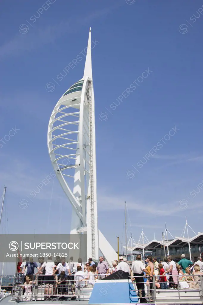 England, Hampshire, Portsmouth, The Spinnaker Tower The Tallest Public Viewing Platforn In The Uk At 170 Metres On Gunwharf Quay With Tourists On The Deck Of A Harbour Tour Boat In The Foreground