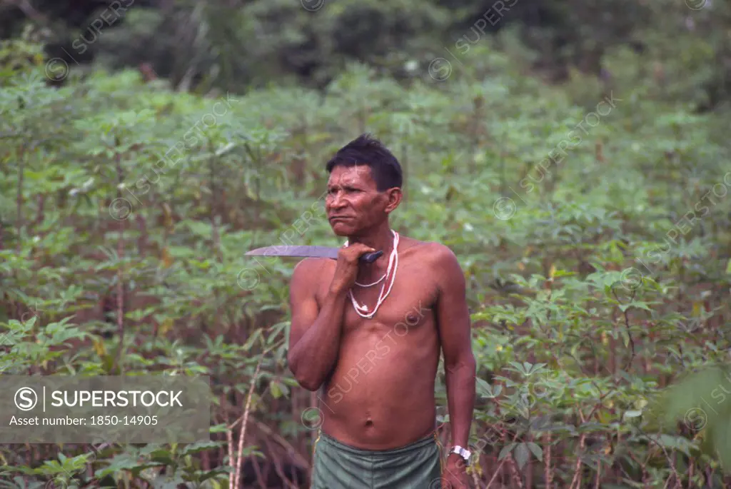 Colombia, Vaupes , 'Tukano Indian Shaman, With Machete And Chewing Coca.'