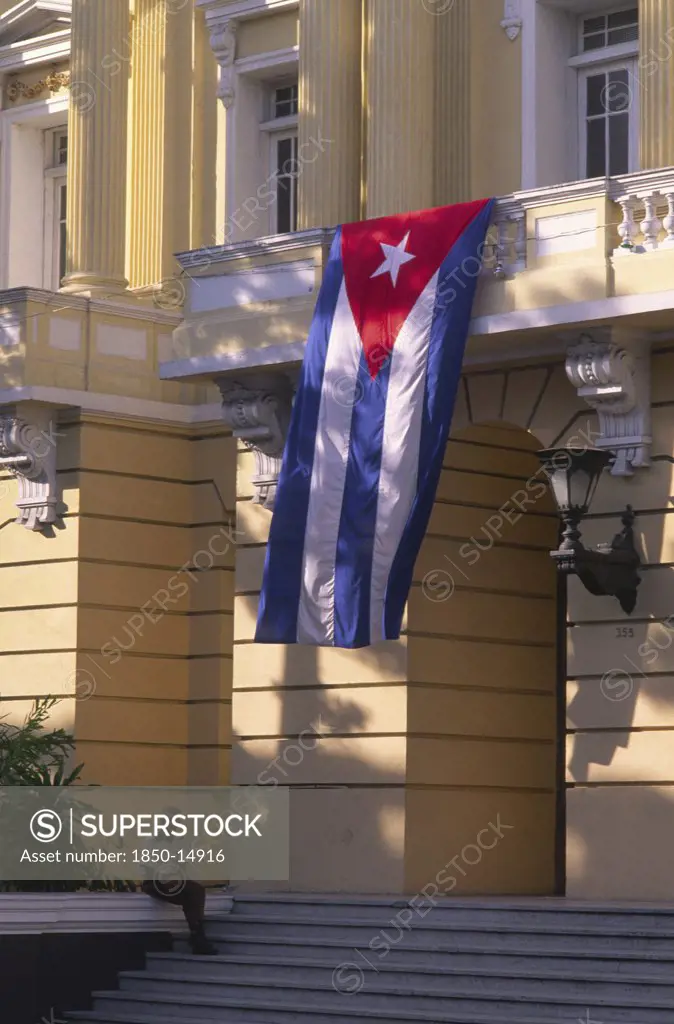 Cuba, Santiago De Cuba, 'Security Guard Sat Outside Government Building, Flying Cuban Flag.'