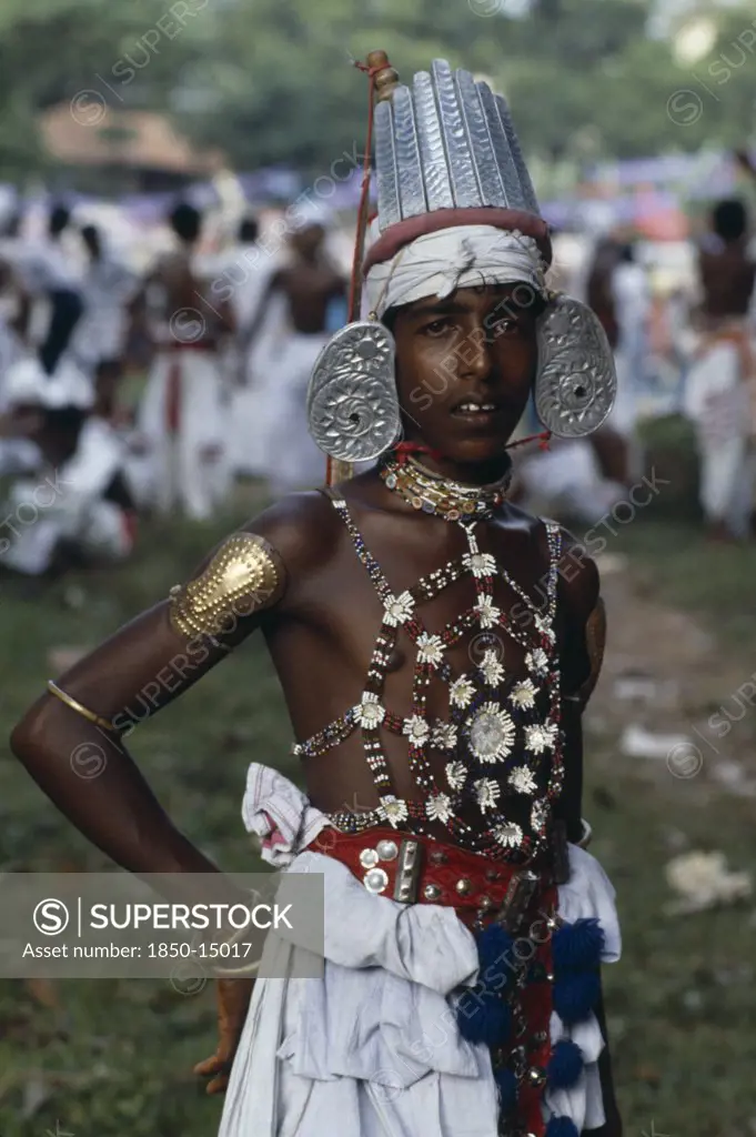 Sri Lanka, Kandy, Portrait Of Young Man Dressed For Kandy Esala Perahera.  Procession To Honour Sacred Tooth Ehshrined In The Dalada Maligawa Temple Of The Tooth.