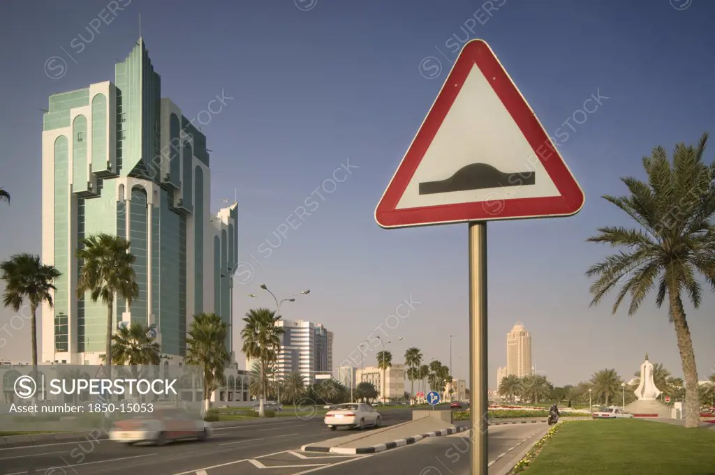Qatar, Doha, 'A Road Sign On The Corniche, Palm Trees Either Side Of The Road.'