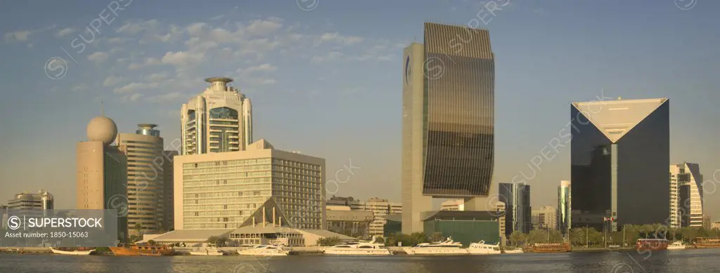 Uae, Dubai., 'View Of Architecture Along The Creek Including The Etisalat Building, The Hilton, The National Bank, And The Chamber Of Commerce & Industry.'