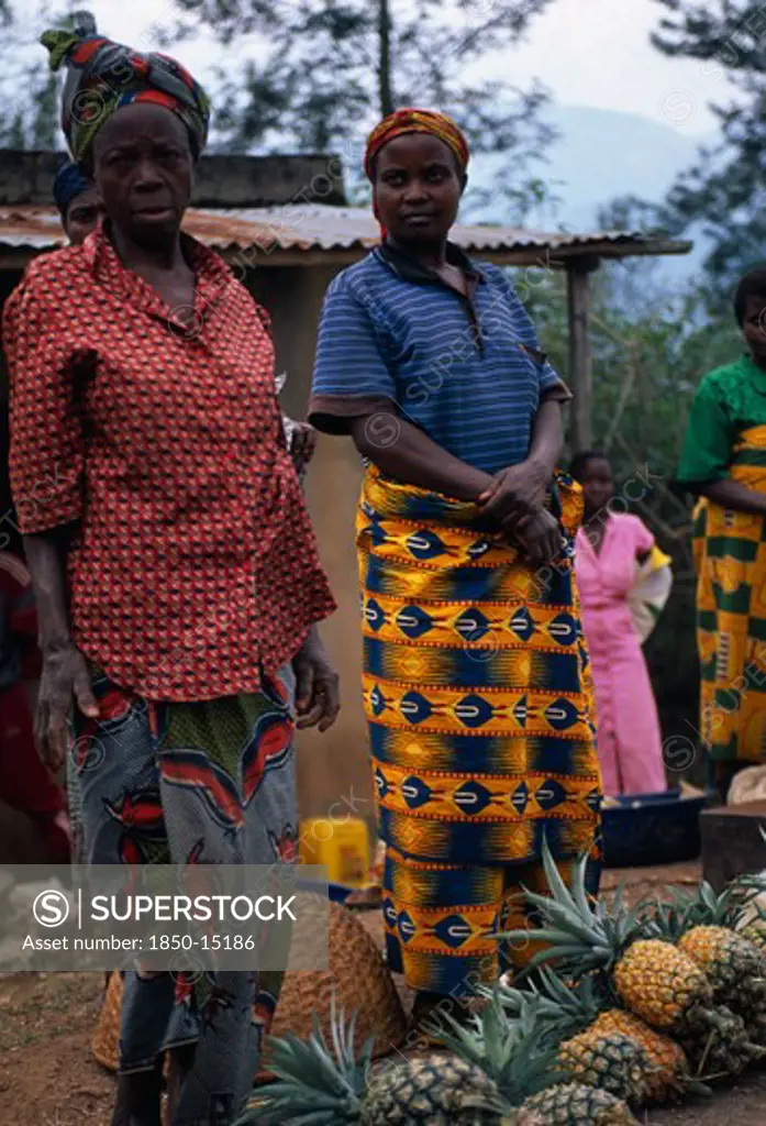Burundi, Market, Fruit, 'Women In Bright Dresses At Side Of Road, Standing Beside Their Pineapples For Sale.'