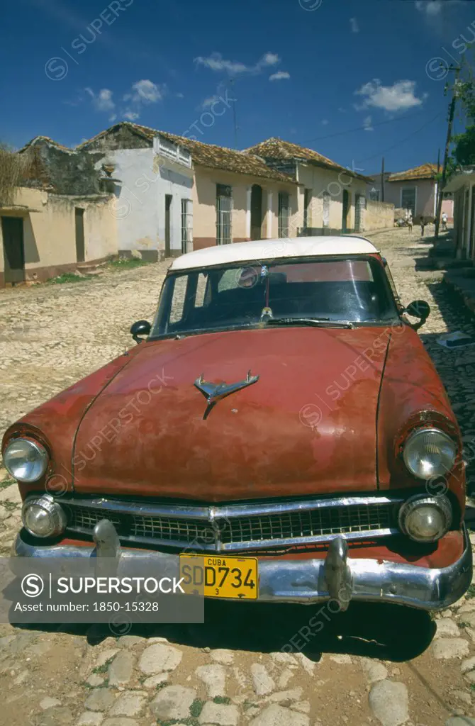 Cuba, Trinidad, Old Red  American Car In Cobbled Street.