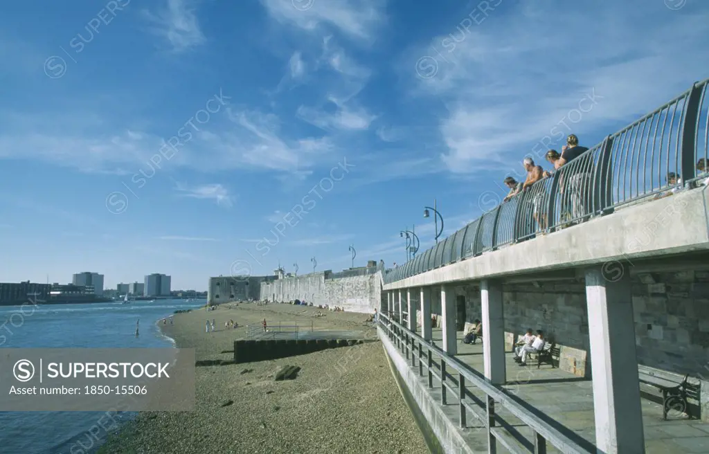 England, Hampshire, Portsmouth, Old Portsmouth. Occupied Strectch Of Beach Next To The Walls With People Looking Over Railings Towards The Square Tower.