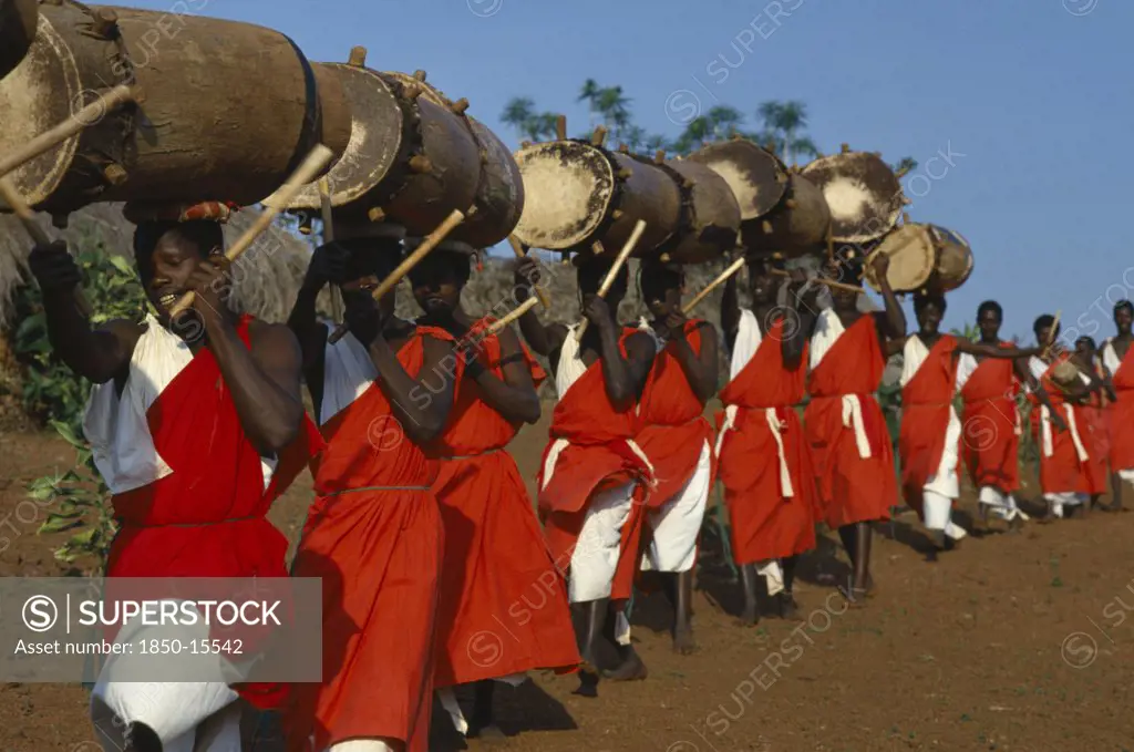 Burundi, Gishora, Line Of Traditional Drummers Or Tambourinaires Dressed In Red And White.