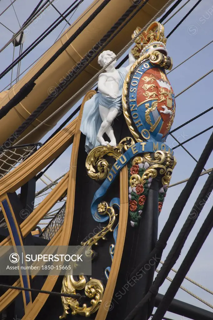 England, Hampshire, Portsmouth, The Bow Of Hms Victory In The Historic Dockyard Showing The Bow Figurehead With Royal Crest.