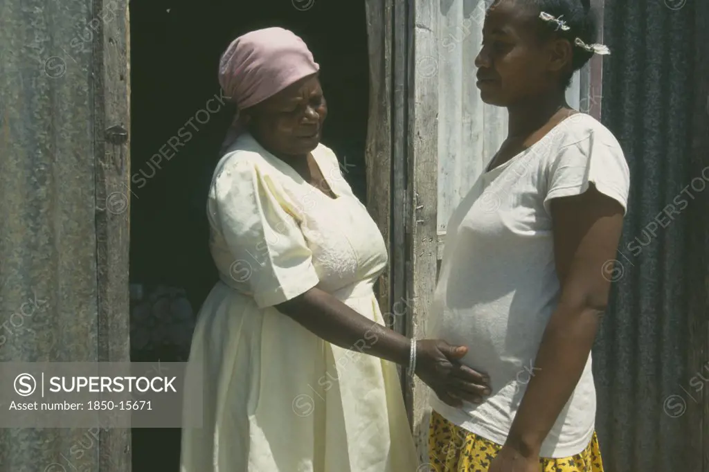 Mauritius, Rodrigues Island, Seventy Year Old Traditional Birth Attendant With Thirty Five Year Old Woman During Her Fourth Pregnancy.