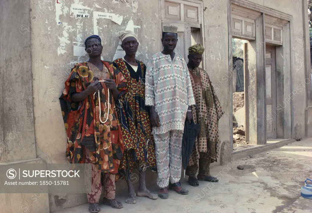 Nigeria, Ede, Full Length Portrait Of Group Of Yoruba Men Wearing Traditional Dress.