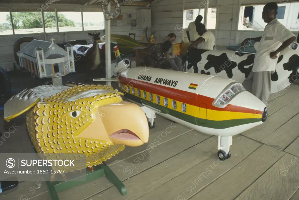 Ghana, Accra, Painted Coffins In The Shap Of A Aeroplane And Eagle.