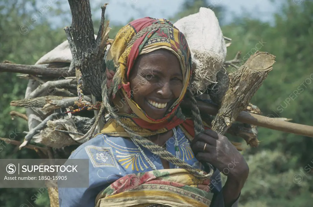 Somalia, Tribal People, Women Carrying Basket Of Firewood On Her Back Near Baidoa.