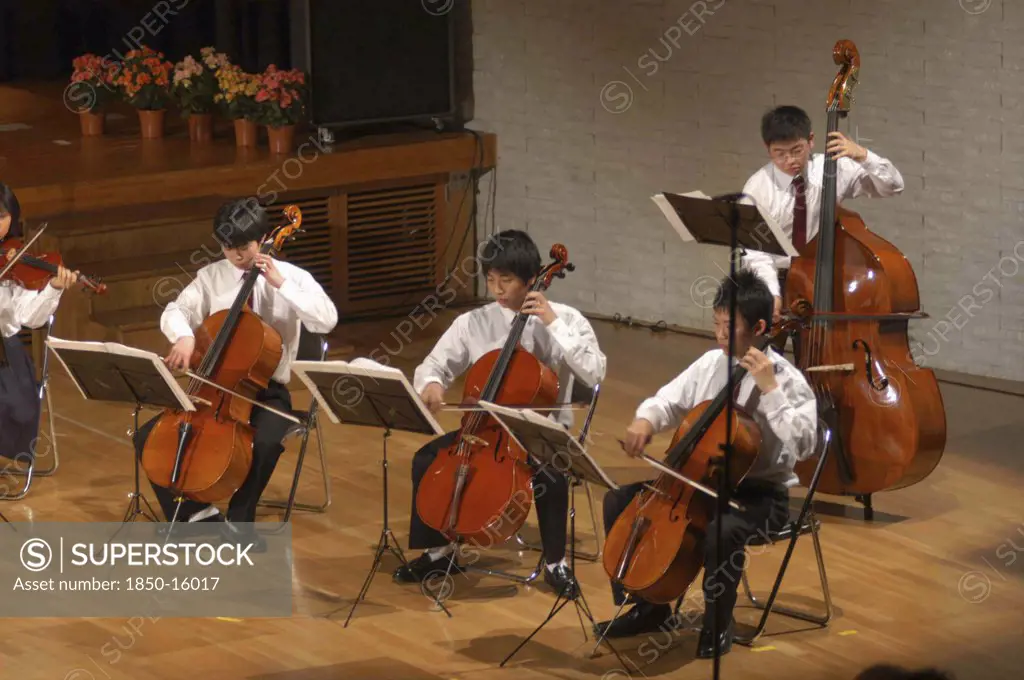 Japan, Chiba, Tako , Teenage Cello Players Performing On Stage At The Spring Concert Of The United Freedom Orchestra