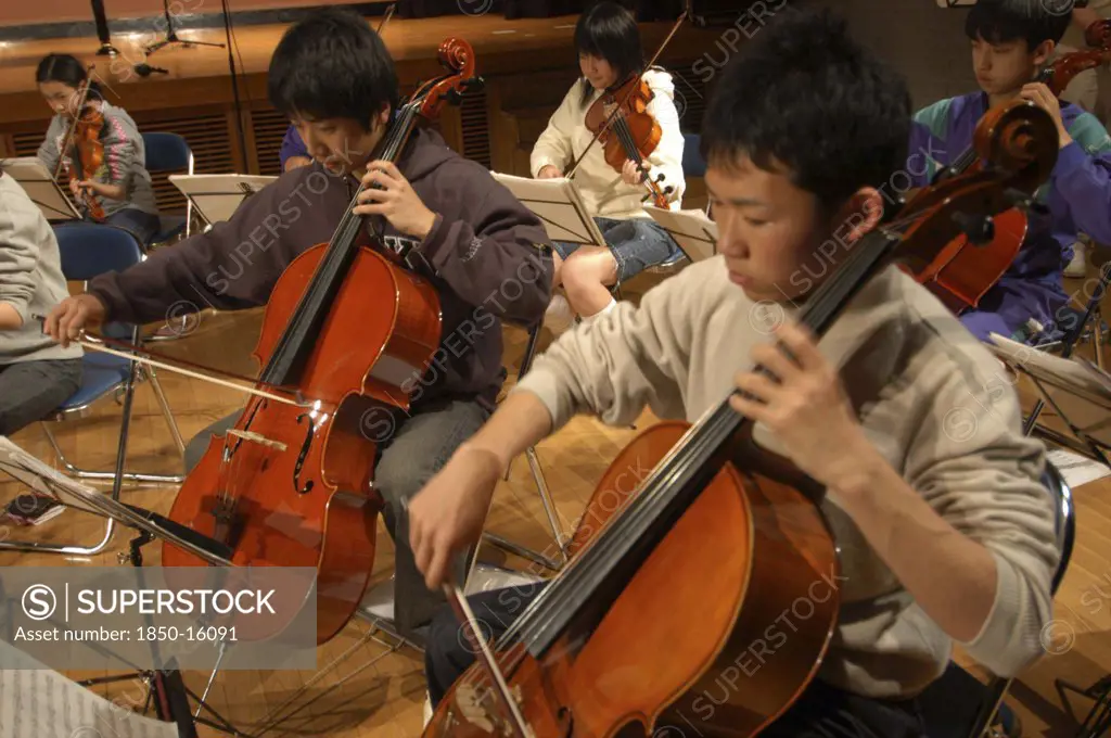 Japan, Chiba, Yokaichiba, High School Teenagers Practicing Cello During Rehearsal For United Freedom Orchestra