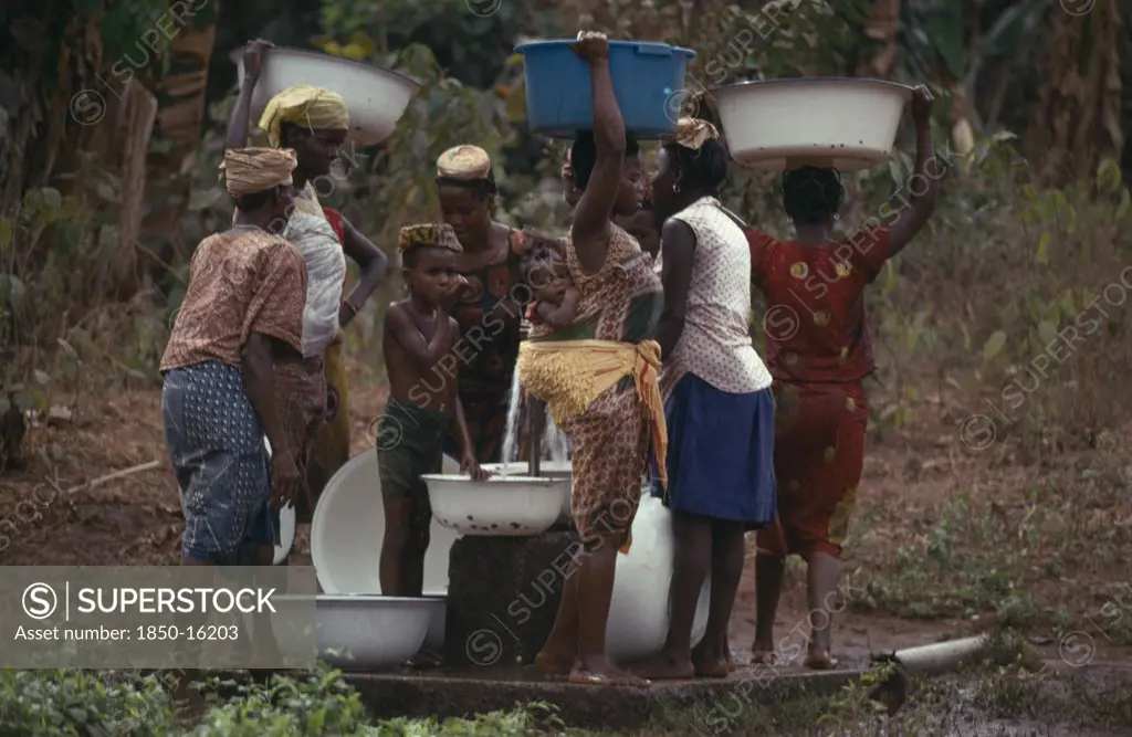 Nigeria, Mid West State, Women And Children Collecting Water At Stand Pipe.