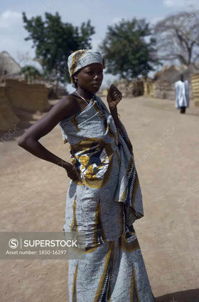 Cameroon, Rey Bouba, Portrait Of Girl Wearing Traditional Batik Fabric And Jewellery.