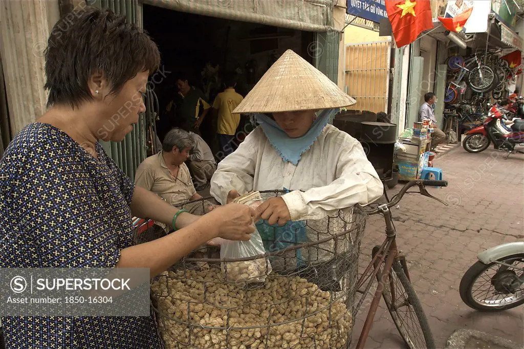 Vietnam, South, Ho Chi Minh City, A Woman Selling Peanuts From Her Bicycle