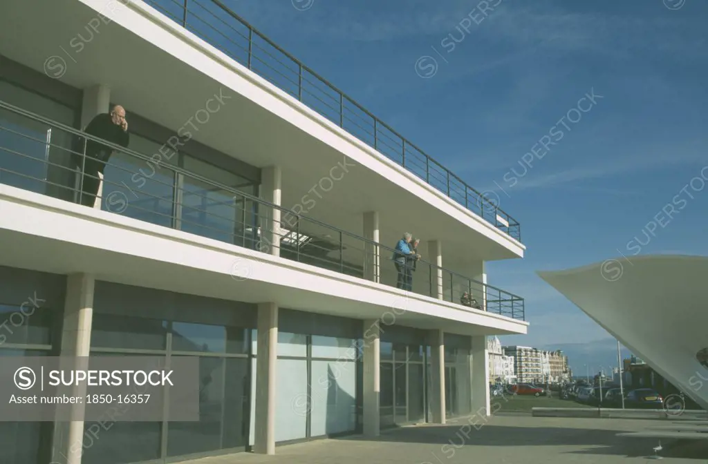 England, East Sussex, Bexhill On Sea, De La Warr Pavilion. Exterior View Of Visitors On Balcony Terrace And Corner Of Bandstand.