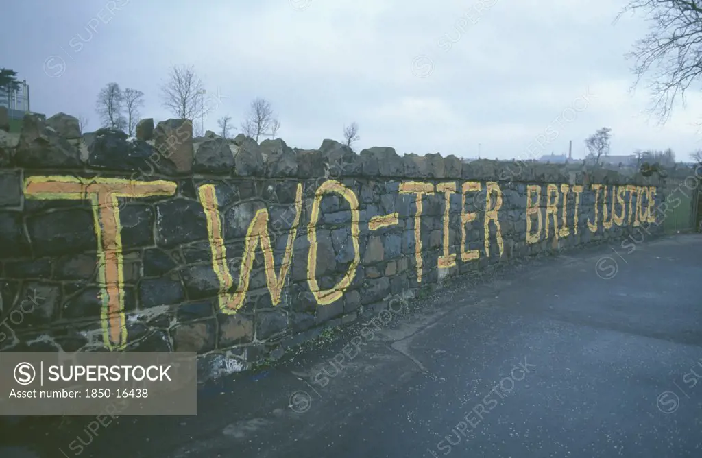 Ireland, North, Belfast, Falls Road. Beechmount Area. Anti British Grafitti On A Wall Saying Two Tier British Justice