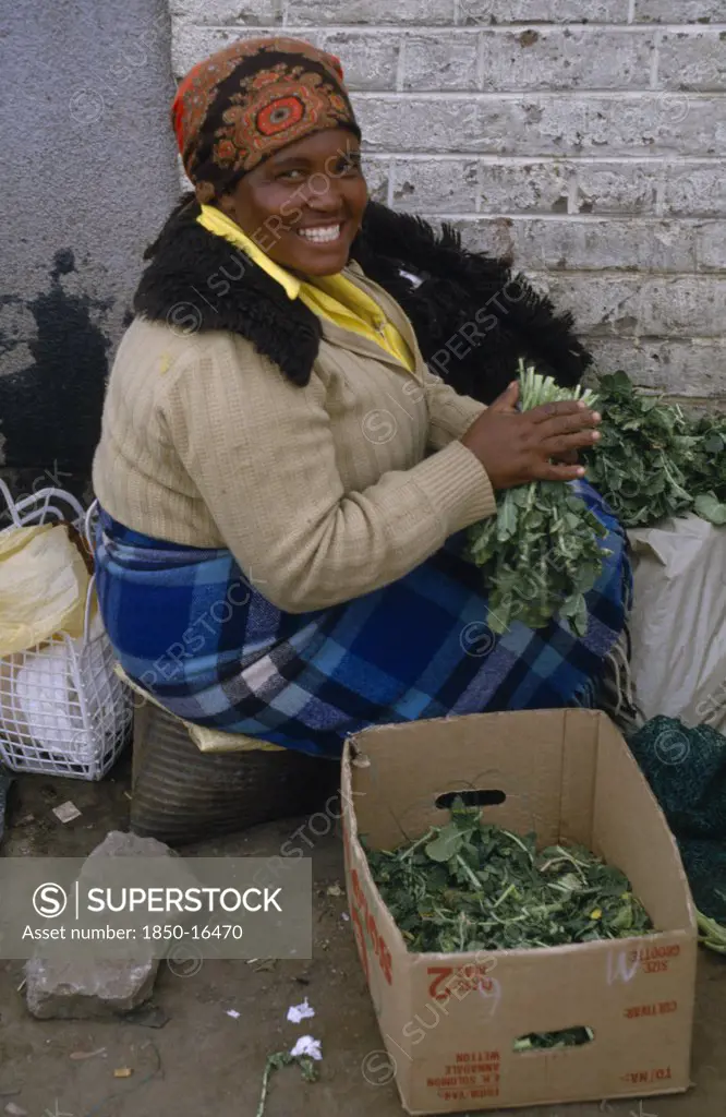 Lesotho, Maseru, Woman At Maseru Market Selling Greens From Cardboard Box