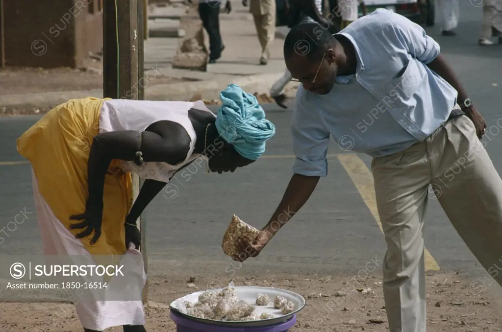 Gambia, Markets, Woman Selling Cashew Nuts To A Man Along The Road Side