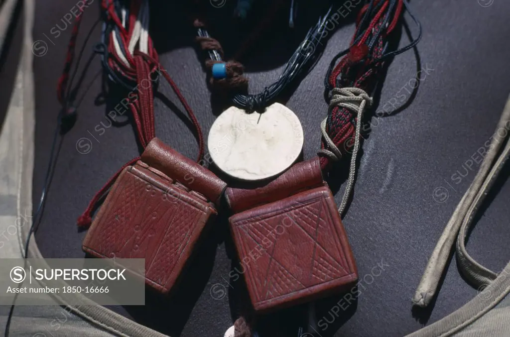 Sudan, Mornei Settlement, Close View Of Leather Pouches Containing Verses Of The Koran Worn As A Charm Around The Neck By Chadian Refugee Woman Together With Old French Coin And Beads.