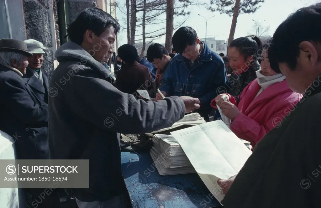 Mongolia, Ulaanbaatar, Newspaper Vendor And Customers.