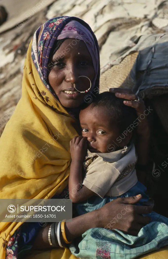 Sudan, North East, Gadem Gafriet Camp, 'Portrait Of Beni Amer Beja Nomad Woman Holding Child, Refugees From Eritrea.'