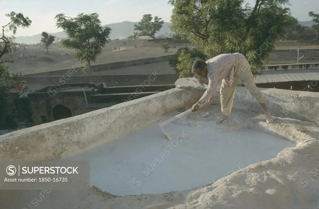 India, Rajasthan, Man Mending The Roof Of His House.