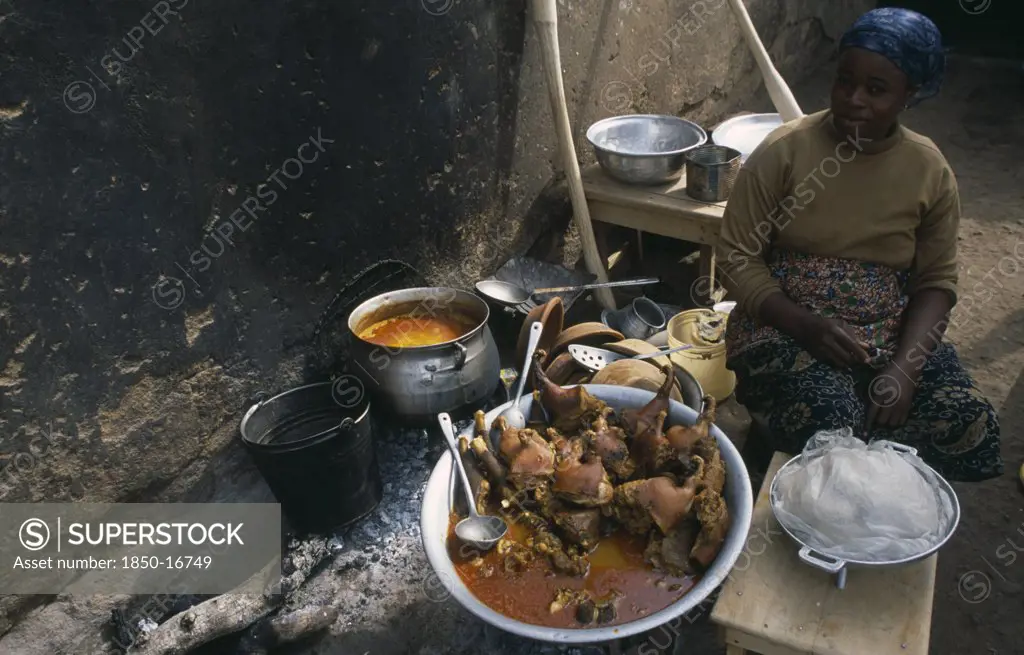 Ghana, Central, Food, Woman Selling Stew Of Guinea-Fowl At Street Food Stall.