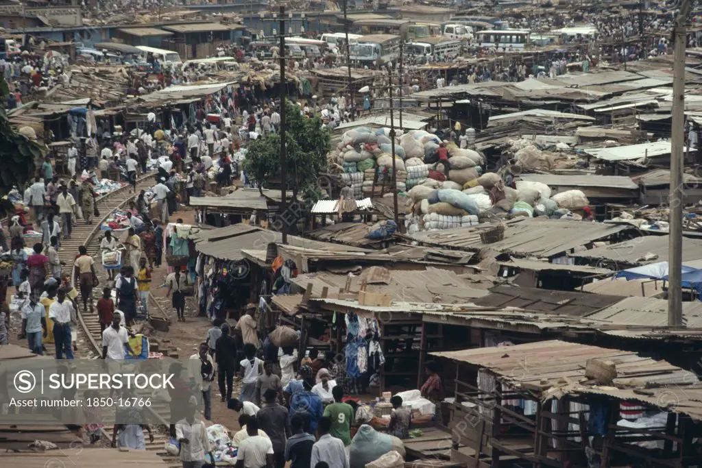 Ghana, Ashanti Region, Kumasi, 'Busy Market Square With Traffic, Crowds Of People And Tin Roofed Open Sided Stalls.'