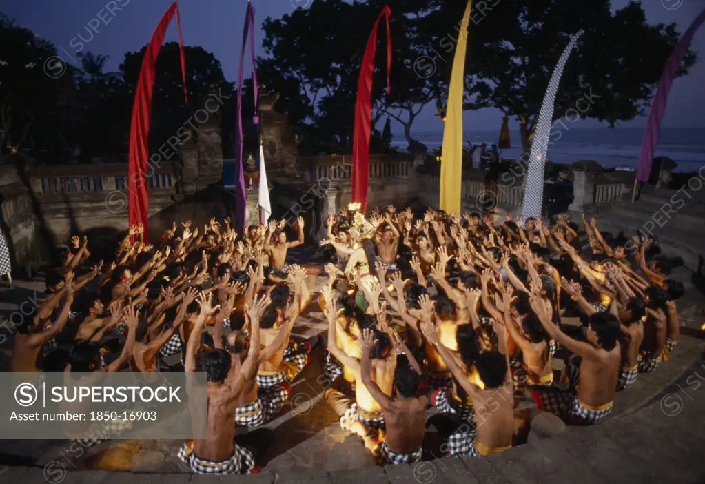 Indonesia, Bali, Kechak Dancers Forming Human Mandala. The Kechak Dance Tells The Story Of Prince Rama And His Quest To Rescue His Wife Sita From The Demon King Ravana