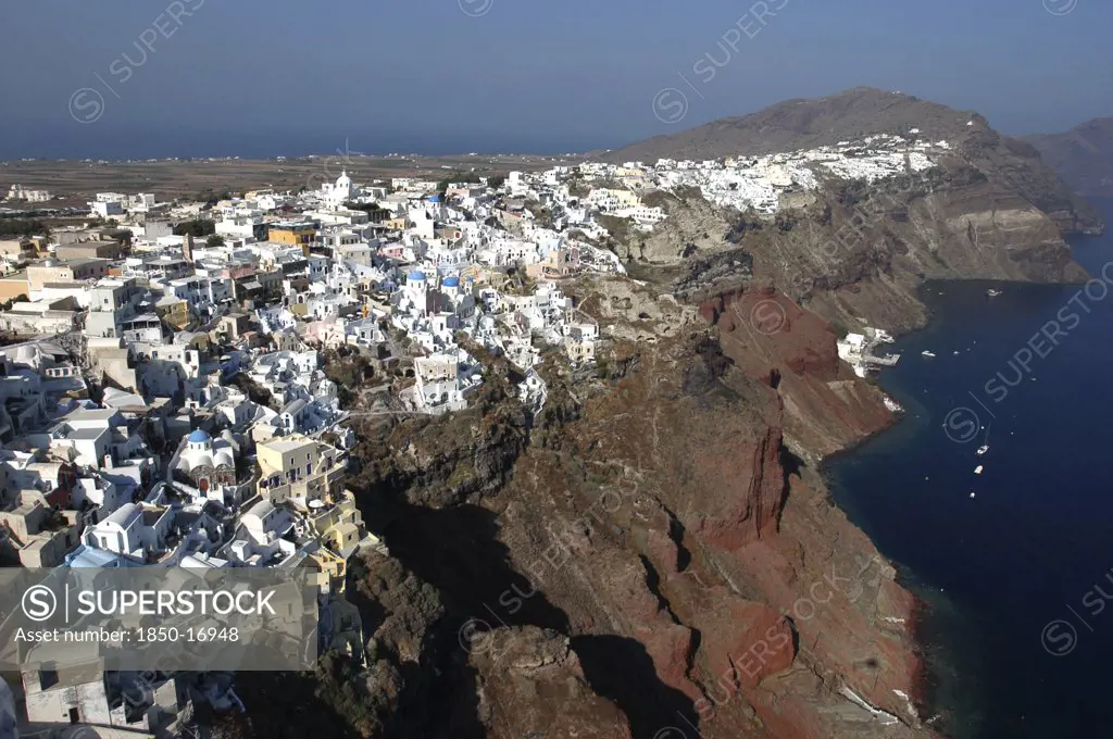 Greece, Cyclades, Santorini, Cliff Top View Over The Towns Architecture With Different Coloured Domed Buildings.