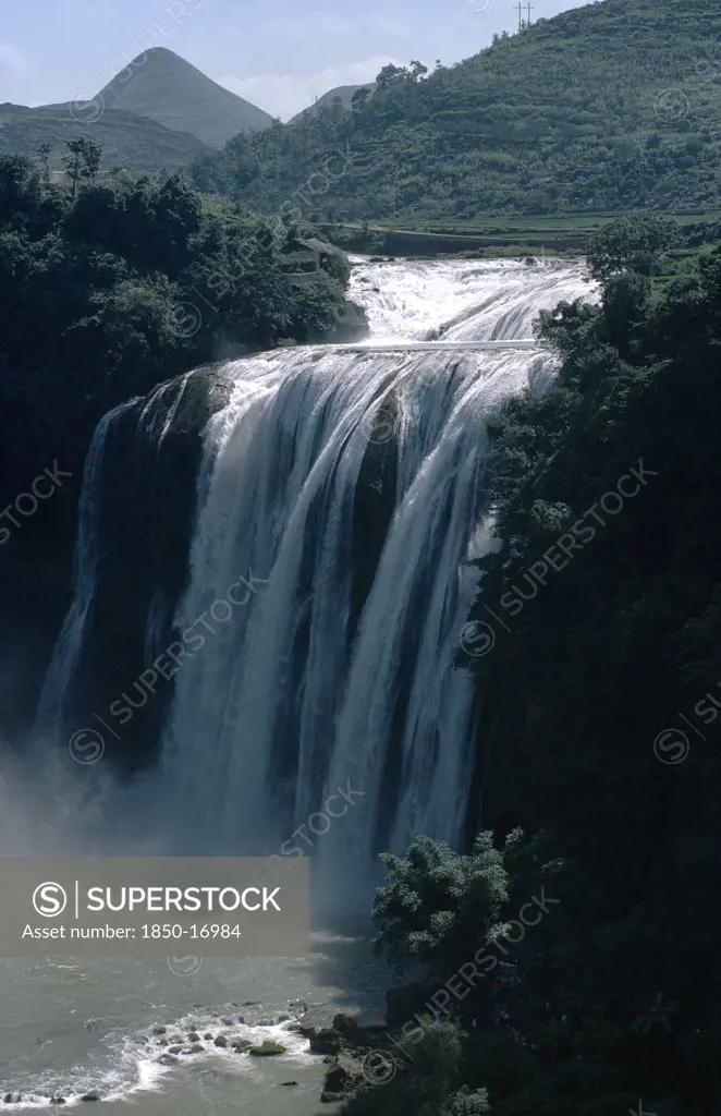 China, Guizhou Province, Huangguoshu Falls, Waterfall Cascading From Vegetation Covered Karst Cliffs.