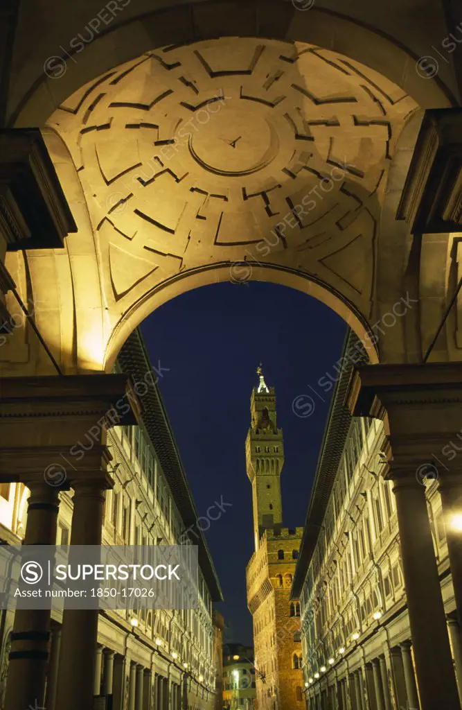 Italy, Tuscany, Florence, Palazzo Vecchio Framed By Arch Of Loggia Medici And Galleria Uffizi At Night.