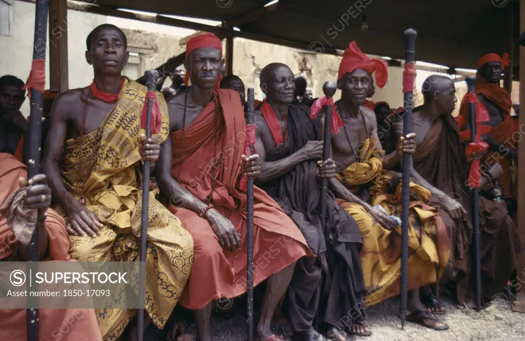 Ghana, Tribal People, Ashanti Akan Tribal Members Holding Staffs Wrapped With Red Cloth Attending Funeral.  Red Is The Colour Of Mourning.