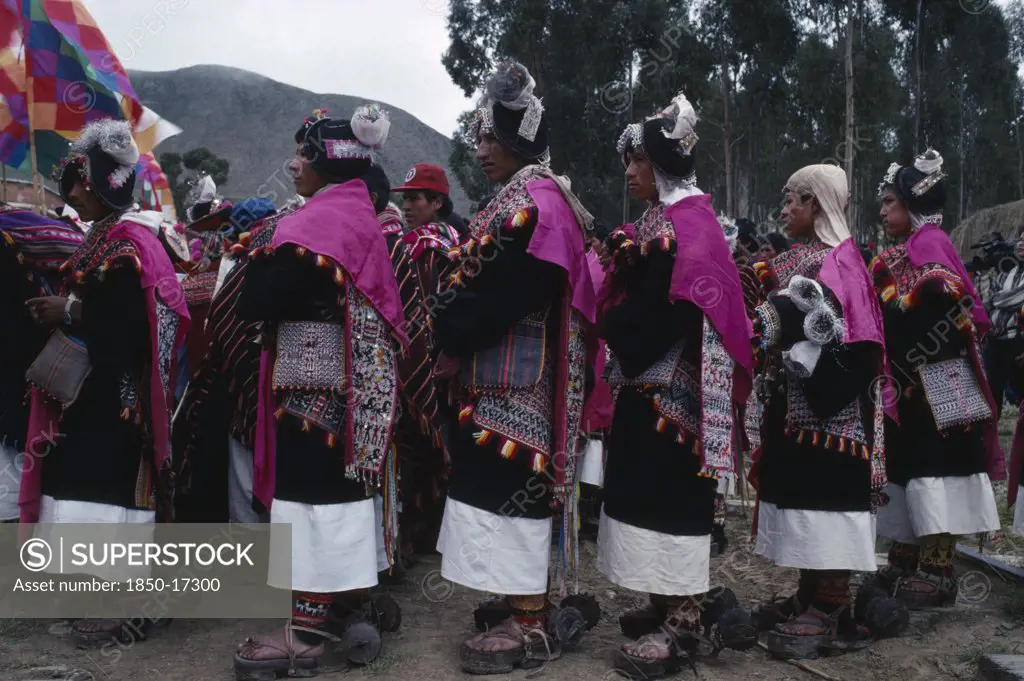 Bolivia, Sucre, Tarabuco, Phujllay Yampara Independence Carnival Celebrations.  Line Of Dancers Wearing Traditional Costume Including Gallos Or Spurs Attached To Their Sandals Or Ojotas.